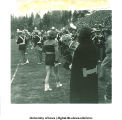 Baton twirler on sidelines of football game, The University of Iowa, 1940s