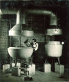 Man pouring liquid into vat for an experiment, The University of Iowa, 1930s