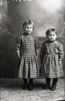 Two girls in plaid dresses