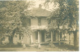 Girls and dog in front of Lust home, Monroe, Iowa, 1910s