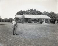 Man stands in front of ranch style house