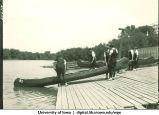Students launching a canoe from a dock, The University of Iowa, 1928?