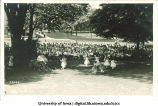 Women dancing on the Pentacrest in front of a large audience at a June celebration, The University of Iowa, 1920