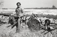 1978 Sid Mais  sits on old farm machinery
