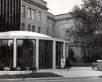 Dr. Garcia and Dianne Hurst  standing outside the rotunda (south) entrance to the 1st library addition