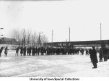Ice skaters in formation on Iowa River, Iowa City, Iowa, between 1925 and 1930