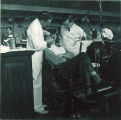 Dental instructor and student examining patient, The University of Iowa, 1940s