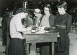 Women filling out Homecoming registration cards, 1956