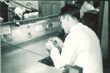 Dental student working on a model in a laboratory, The University of Iowa, 1940s