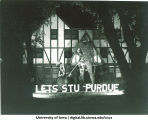 Homecoming decorations in front of Greek house, The University of Iowa, 1940s