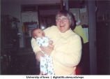 Faculty member holding a baby, The University of Iowa, 1990s