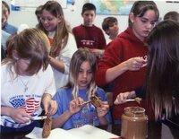 Students make pine cone bird feeders