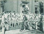 Students performing acrobatic trick on bicycle, The University of Iowa, 1940s