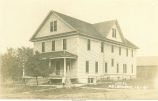 Girl outside hotel, Melbourne, Iowa, May 5, 1917