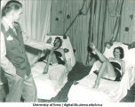 Students playing ring toss game at Homecoming event, The University of Iowa, 1940s