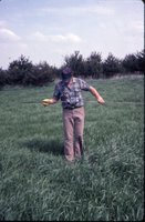 Tim [?] checking water level depth, 1983