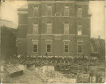 Crew standing in front of Calvin Hall during its move across Jefferson Street, The University of Iowa, 1905