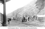 Group of people, buildiings and railroad tracks at the base of a mountain, Silver Plume, Colo., late 1890s or early 1900s