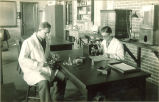 Students performing lab experiments, The University of Iowa, 1920s?