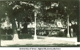 Summer commencement on the Pentacrest with Clinton Street business district in background, The University of Iowa, July 1923