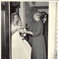 Frindy, Elizabeth and unknown man in front hall with correspondance