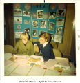 Judy Hoard and unknown woman at WRA display and information table, The University of Iowa, December 1968