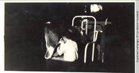 Man milking cow in barn
