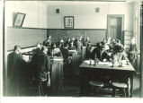 Instructor Bohumil Shimek with students in Calvin Hall classroom, The University of Iowa, 1900