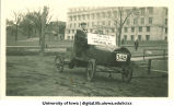 Sanitary engineering students in old car for sale, Homecoming parade, The University of Iowa, 1917