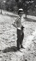 1978 Man stands in field by camera