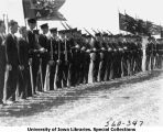 Governor's Day ceremony, ROTC formation holding guidons and rifles, The University of Iowa, 1931