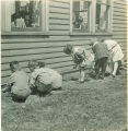 School children gardening by house, The University of Iowa, 1925