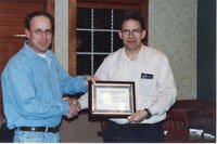 2004 Mediapolis teacher  Ralph Kauffman accepts Teacher of the Year conservation  award from Chairperson Todd Heckenberg 