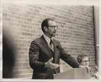 Man with Glasses Speaking at Meeting