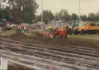 Red tractor and plow being driven at the Plymouth County Fair in July 1996.