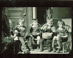Children sitting on chairs with musical instruments, The University of Iowa, February 22, 1938