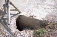 1990s Hole in concrete on road