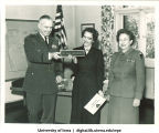 Jean Homewood of the US Army Europe Special Services Athletic Program receiving her nameplate, The University of Iowa, November 13, 1957