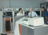 Earl O. Heady hearing about upgraded equipment at the Office of Agricultural Economics computer center in Bangkok, Thailand, 1983.