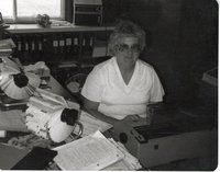 Chris Botts is typing at her desk