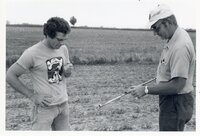 1978 Two men look at pipe