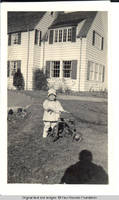 Vidie Burden with tricycle in front of White house