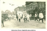 Men in white smocks marching in parade, The University of Iowa, 1910s