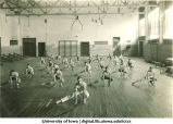 Students stretching in a gymnasium, The University of Iowa, 1930s