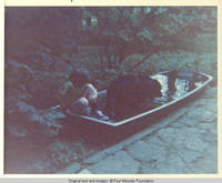 John, Jr. and Sadie in boat/pool, outside the white house along the lane