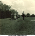 Group of officers standing at attention near a flag, The University of Iowa, 1950s