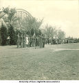 Officials and military officers standing at attention for Governor's Day ceremonies west of Armory, The University of Iowa, 1940s?