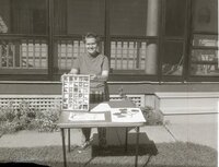 Unidentified woman shows rock samples in tray