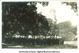 Graduates gathered on Pentecrest for commencement, with Old Capitol in background, The University of Iowa, June 12, 1918