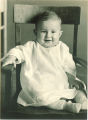 Smiling baby in a chair, The University of Iowa, 1920s
